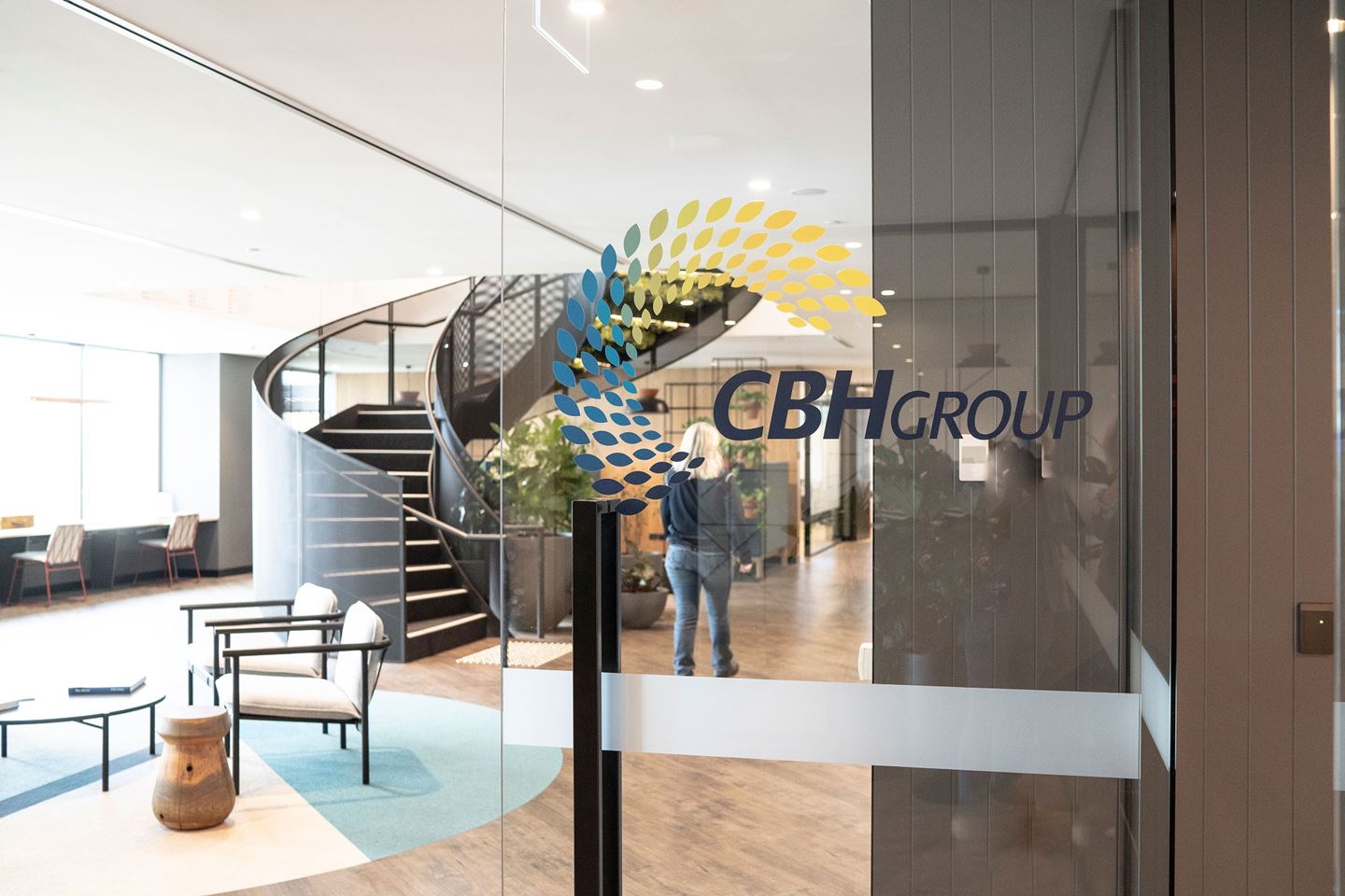 A glass door with the CBH Group logo shows the reception area and spiral staircase of CBH Head Office behind it